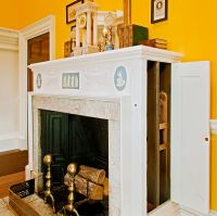 Wine dumbwaiter in side of Dining Room fireplace
