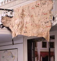 Image of Buffalo hide with war scene pictographs hanging from Entrance Hall balc