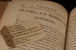 A tiny scrap of paper with Greek notes in Jefferson's hand tucked in Plutarch. Washington University Libraries, Department of Special Collections.